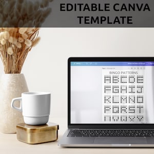 May include: A laptop computer displaying a Canva template for bingo patterns. The template has 25 different bingo patterns, each with a 5x5 grid. The laptop is on a white desk with a white mug and a gold box.
