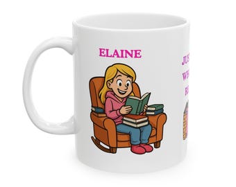 May include: White ceramic mug featuring a cartoon illustration of a girl reading in a rocking chair. The name "Elaine" is above the illustration in pink text. The mug also has text that reads "Just Where I Read".