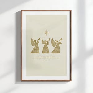 May include: A framed print featuring three golden angels playing trumpets beneath a star. The artwork includes the text "Glory to God in the highest, and on earth peace, goodwill toward men, Luke 2:14."