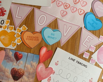 May include: A set of Valentine's Day themed educational activities for kids. The set includes a banner with the word "LOVE" in pink, a line tracing worksheet, and several heart-shaped stickers with different messages. The stickers include "Friends Forever", "Be Mine?", "Hugs & Kisses", and "You So Cool".