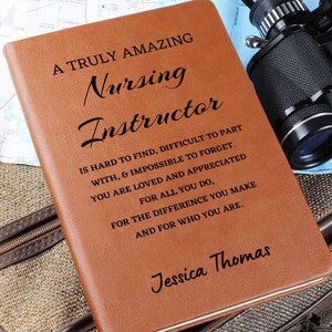 May include: A brown leather journal with the text "A Truly Amazing Nursing Instructor" and a personalized message for Jessica Thomas. The text reads: "Is hard to find, difficult to part with, & impossible to forget. You are loved and appreciated for all you do, for the difference you make and for who you are."