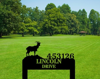 May include: Black metal yard sign featuring a goat silhouette and the address "453126 LINCOLN DRIVE". The sign is set against a backdrop of a green lawn and trees under a blue sky.