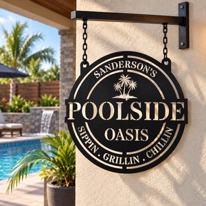 May include: A circular black metal hanging sign with a matte finish, suspended by two black chains from a wall-mounted bracket. The sign features cut-out text reading SANDERSON'S POOLSIDE OASIS and SIPPIN. GRILLIN. CHILLIN, with a palm tree graphic.