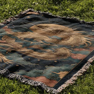 a large, intricately designed rug with a dragon motif, resting on a grassy field.