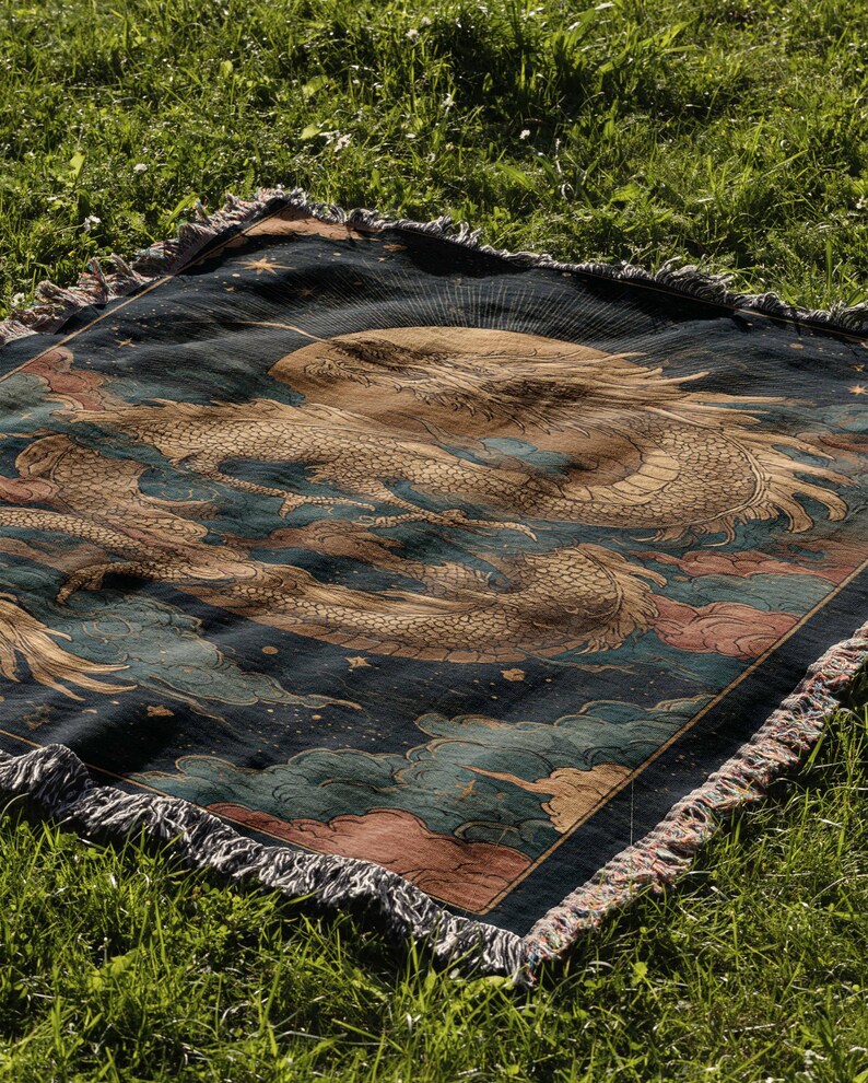 a large, intricately designed rug with a dragon motif, resting on a grassy field.