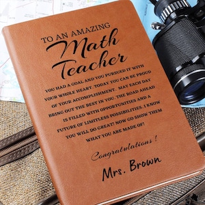 May include: A brown leather journal with the text "To an amazing Math Teacher" and a message of congratulations to Mrs. Brown.