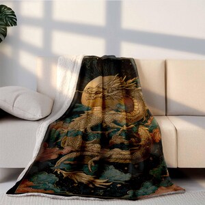 a large, colorful dragon-themed blanket draped over a white couch, with a plant visible in the background.