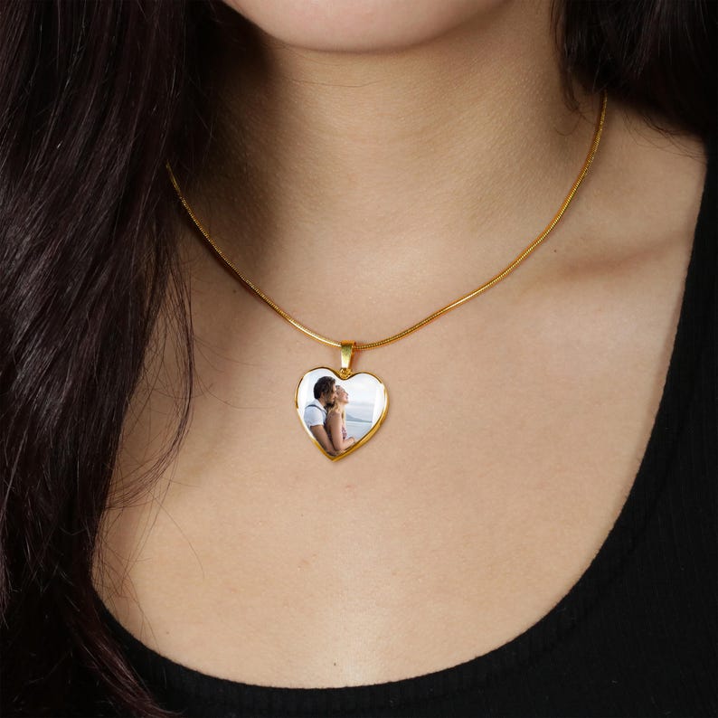 a woman wearing a necklace with a heart shaped photo