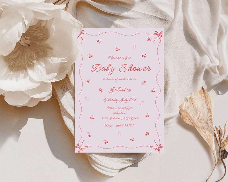 May include: Pink baby shower invitation with a red string border and red illustrations of cherries, pacifiers, and a rattle. The text reads "Please join us for a Baby Shower in honor of mother-to-be Juliette, Saturday July 21st, from 11 am to 4 pm, at her home, 1234 Johnson St. California, RSVP 555-098793."