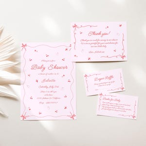 May include: Pink baby shower invitation cards with a delicate floral design. The cards include a main invitation, a diaper raffle card, and a thank you card. The text on the main invitation reads "Baby Shower in honor of Juliette, Saturday, July 21st, 12:30-4:00pm, The Loft, 1234 Somewhere Drive, City, State, 12345".