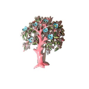 May include: A pink enamel tree brooch with blue and green enamel flowers and clear rhinestones.