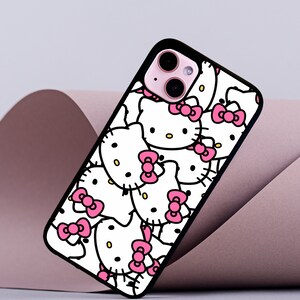 May include: Black phone case with a white background and a pattern of pink Hello Kitty characters.