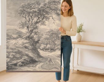 May include: A black and white landscape drawing of a winding path through a forest with a large tree in the foreground. The drawing is on a canvas and is being held by a person.