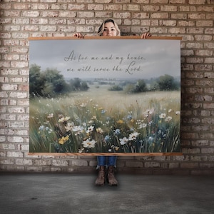 May include: A framed canvas print featuring a pastoral landscape with wildflowers and trees under a cloudy sky. The artwork includes the text "As for me and my house, we will serve the Lord. Joshua 24:15."