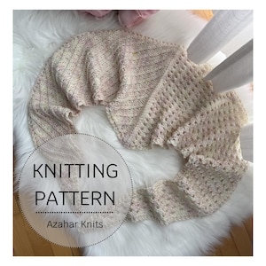 May include: A cream-colored knitted shawl with a textured design and scalloped edges. The shawl is displayed on a white fluffy surface. The text "KNITTING PATTERN" and "Azahar Knits" are visible in a circular graphic.