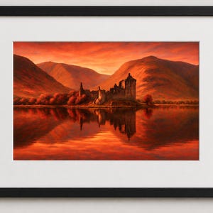 May include: A framed print of a landscape featuring a castle ruin on a small island in a lake. The artwork is dominated by warm tones of red and orange, with the castle and surrounding mountains reflected in the water.