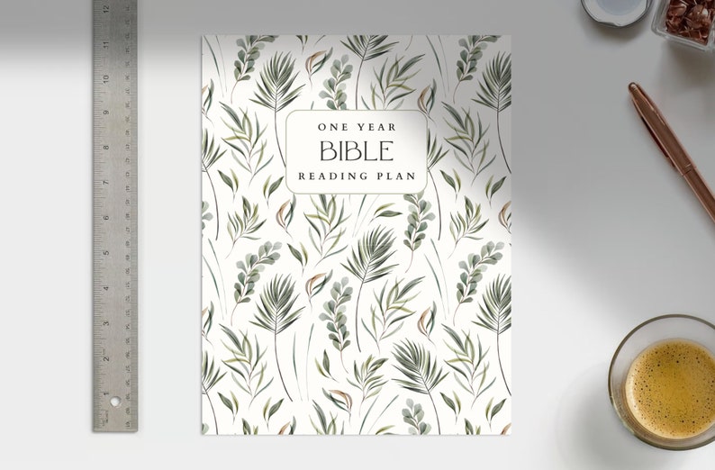 May include: A white planner with a green leafy pattern and the text "One Year Bible Reading Plan".