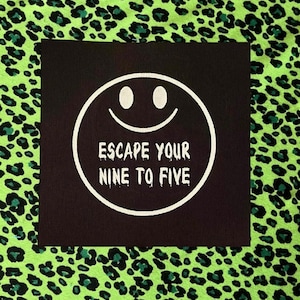 May include: A black square fabric patch featuring a white circular smiley face graphic with the text ESCAPE YOUR NINE TO FIVE printed in a dripping font style, positioned against a bright neon green fabric with a black leopard print pattern.