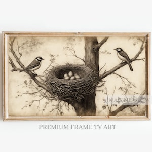 May include: A sepia-toned framed print featuring two birds perched on tree branches, with a nest containing eggs in the center. The artwork has a vintage aesthetic, with the text "PREMIUM FRAME TV ART" at the bottom.