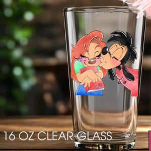 May include: A clear 16 oz glass featuring a cartoon illustration of two characters kissing. The characters are in shades of red, pink, green, and blue. The text "16 OZ CLEAR GLASS" is printed at the bottom of the glass.