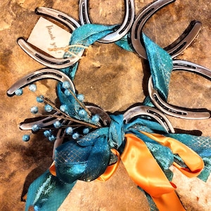 Smaller pony horseshoe Christmas wreath! Wrapped with festive ribbon and added touches make for a unique piece. Custom shipping available