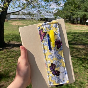 May include: A set of three ceramic mugs with a speckled, matte finish. The mugs are in shades of cream, light gray, and dark gray. Each mug has a simple, minimalist design, perfect for coffee or tea.