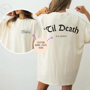 May include: A cream colored t-shirt with the text "'Til Death Est. MMXXV" printed on the back. The front of the shirt has the word "Forever" printed on it.