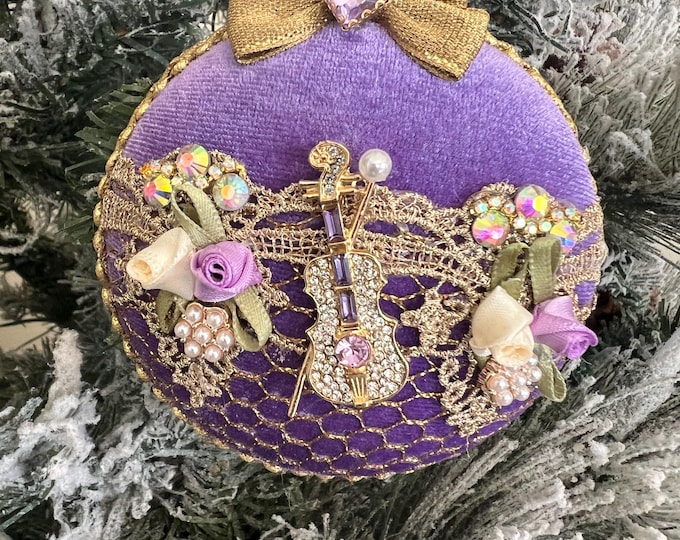 Lilac Victorian Christmas ornaments with gold lace, pearls, flowers, and a jeweled violin.