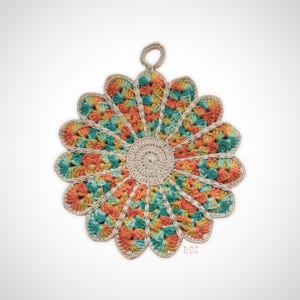 May include: A round, crocheted potholder featuring a central beige circle surrounded by petal-like segments in variegated shades of orange, yellow, and teal. The entire piece is outlined in beige yarn and includes a small loop at the top for hanging.