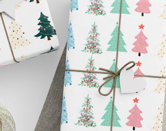 May include: Several wrapped gifts with festive Christmas tree patterns in green, pink, and blue on white paper. Each gift is tied with twine and a decorative tag. A ball of twine, scissors, and blank tags are also present.
