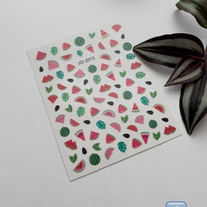 May include: A sheet of watermelon, leaf, and seed stickers. The stickers are on a white background and feature a variety of watermelon slices, leaves, and seeds. The sheet is labeled "JO-2015".