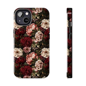 May include: A floral phone case featuring a dark background with a pattern of red, pink, and cream-colored flowers. The case has a black border and a camera cutout.