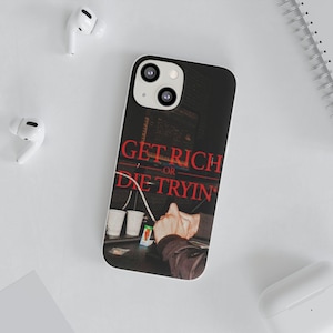 May include: A black and white phone case with the text "GET RICH OR DIE TRYIN" in red. The case features an image of hands, cups, and a cityscape. White wireless earbuds are visible in the background.