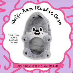 May include: A gray Wolf-chan plushie case with a white face and black details. The case is approximately 8.3 x 4.3 x 1.6 inches in size. The text "Wolf-chan Plushie Case" and "This is an actual product photo" are also visible.