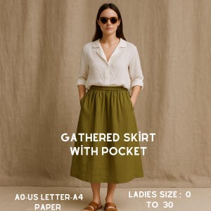 May include: A woman in a white shirt and an olive green gathered skirt with pockets. The skirt is mid-calf length. Text on the image reads "GATHERED SKIRT WITH POCKET" and "LADIES SIZE; 0 TO 30".