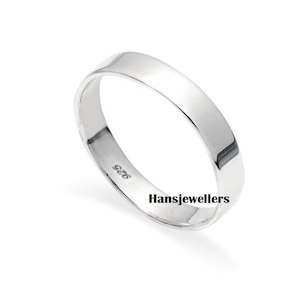 May include: A simple silver band ring with a smooth, flat surface. The inside of the band is stamped with "926" and "Hansjewellers".