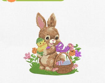 May include: Embroidered design of a brown bunny holding a yellow chick and a basket of Easter eggs. The bunny is surrounded by pink, purple, and yellow flowers. The design is available in PES, DST, JEF, EXP, and VP3 formats and measures 5 to 9 inches.