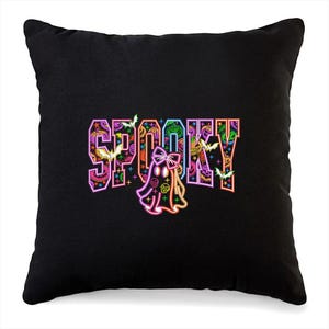 May include: Black throw pillow with the word "SPOOKY" in colorful, neon-style lettering. The design includes bats, stars, and a ghost with a bow. The letters are filled with Halloween-themed patterns.