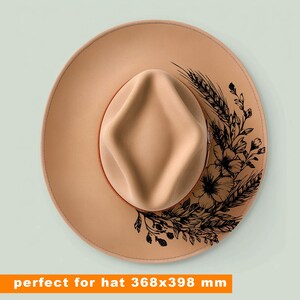 May include: A tan-colored hat with a wide brim and a structured crown. The hat features a floral and wheat design in black ink on the brim. The text "perfect for hat 368x398 mm" is at the bottom of the image.