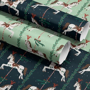 May include: Rolls of wrapping paper with a repeating pattern of carousel horses in white and brown, accented with red and green details. The background alternates between a dark teal and a light green, with a festive holiday theme.