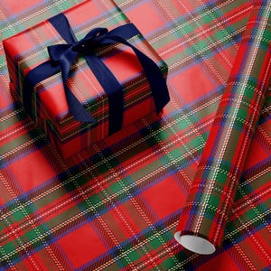 May include: A wrapped gift box and a roll of wrapping paper with a red plaid pattern. The gift box is tied with a navy blue ribbon. The plaid design includes red, green, blue, and white lines.