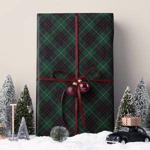 Green tartan plaid paper with a classic look, perfect for wrapping traditional Christmas gifts.