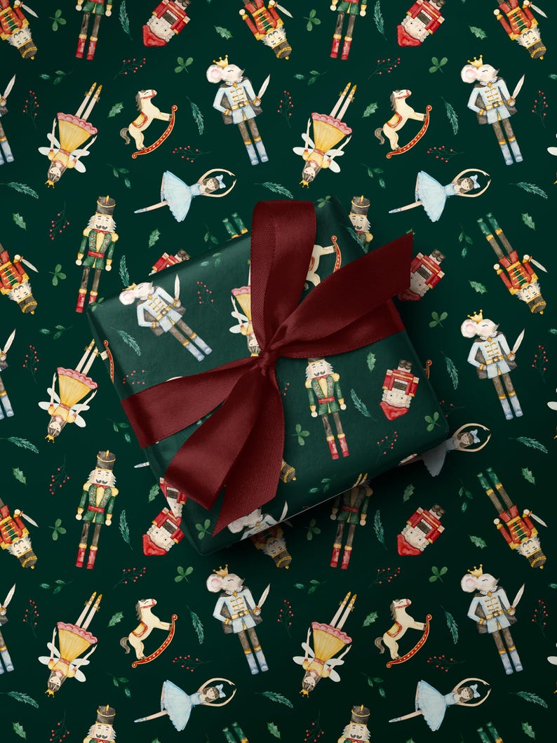 May include: Dark green wrapping paper with a repeating pattern of watercolor illustrations of nutcrackers, mice, ballerinas, and rocking horses. A wrapped gift with a burgundy bow is in the center.