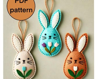 May include: Three felt Easter bunny ornaments with a flower design. The bunnies are light brown, light blue, and orange. Each bunny has white felt ears and a white felt flower with a green stem.