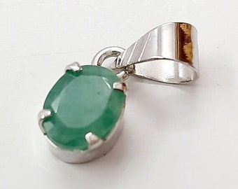 May include: A silver pendant with a green oval gemstone.