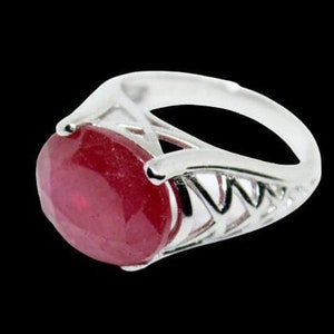 May include: A silver ring featuring a large, oval-shaped, red gemstone set in a delicate, openwork design.