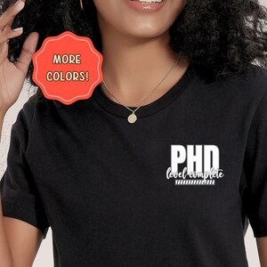 May include: Black t-shirt with white text that reads "PhD level complete".