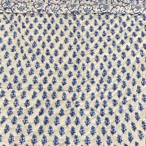 May include: White cotton duvet cover with a blue floral pattern. The pattern features small, stylized flowers with blue leaves.