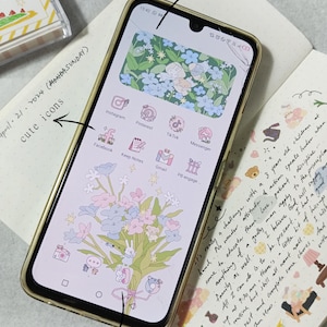 May include: A smartphone with a floral wallpaper and a cracked screen. The home screen has icons for Facebook, Instagram, Pinterest, TikTok, Messenger, Keep Notes, Gmail, and PB engage. The text "April 21, 2024 (MONDASUNDAY)" and "cute icons" are written on the screen. The text "homescreen" and "widget wallpaper" are written on the background.
