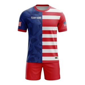 May include: A red, white, and blue soccer uniform set. The jersey is split vertically, with a blue geometric pattern on the left and red and white stripes on the right. The shorts are solid red. The jersey has the text "TEAM NAME".
